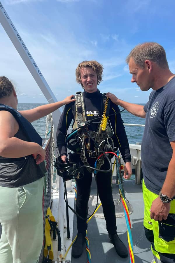 A dressed up diver without a mask