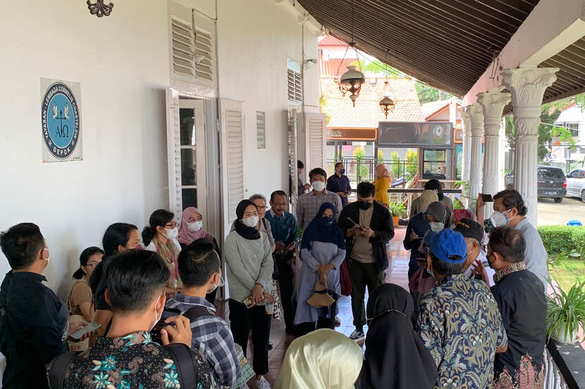 A group of people standing on a veranda of a historic center in Depok (Indonesia)