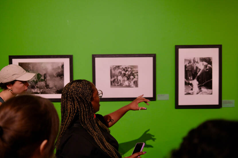 Cursist Phumzile Nombuso Twala points at a black and white picture of Ernest Cole while explaining the story behind it.