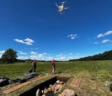 Drone flying above a hole in the ground