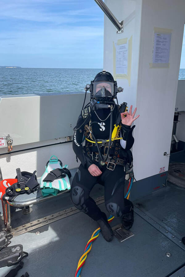 A dressed up diver with a full face mask