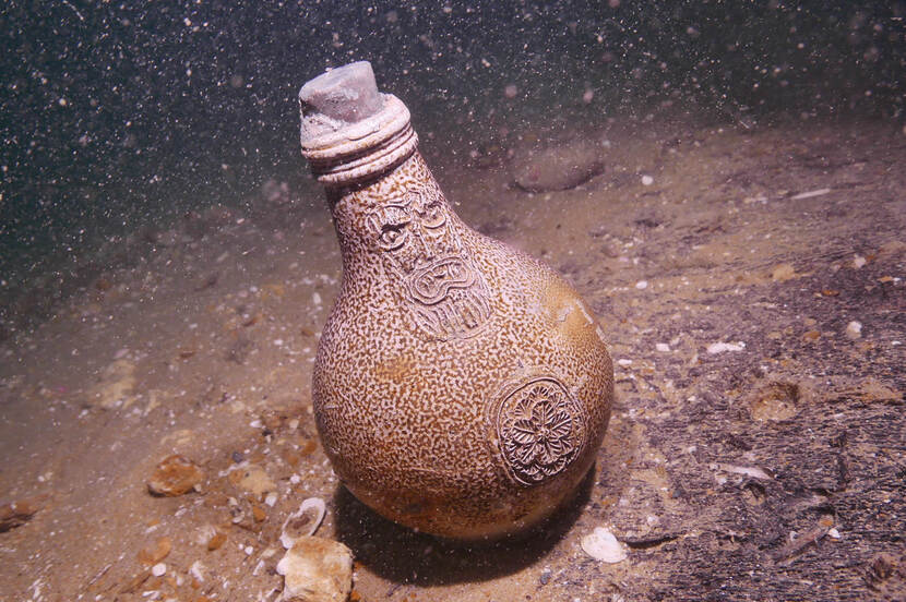A jug with the face of a bearded man on the bottom of the sea